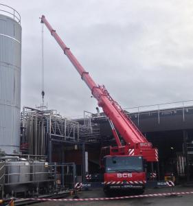 Crane lifting silo